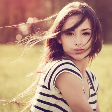 Beautiful Young Woman With Wild Long Hair On Nature Summer Backg