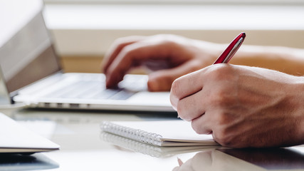 Hand with pen in office