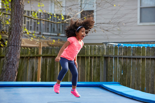 Kid Toddler Girl Jumping On A Trampoline