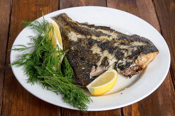 grilled flounder on the white plate
