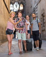 Couples with baggage walking the city.