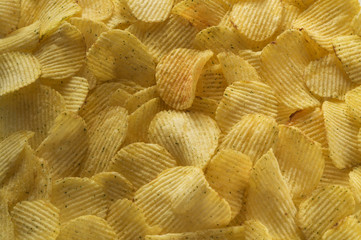 Closeup potato chips background, top view.