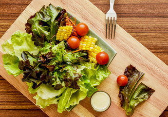 
Fresh vegetable salad on wood background.Flat lay,top view.