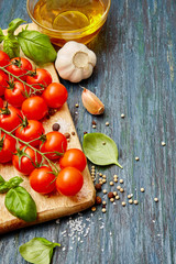  Vegetables, spices and oil on a board. Vegetarian food, healthy food concept. Dark  background. Top view. Flat lay. Organic food. 
