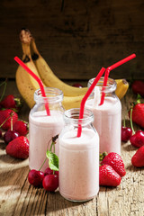 Strawberry Banana smoothie with cherry in glass bottles, vintage