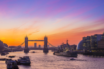 Obraz na płótnie Canvas London, England - Tower Bridge and HMS Belfast cruiser at sunrise with amazing sky 