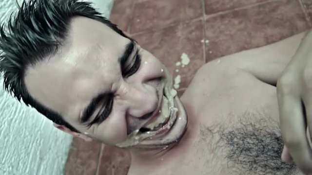 Drunk man on the floor laughing
