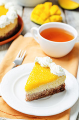 mango cheese cake decorated with whipped cream and mango puree