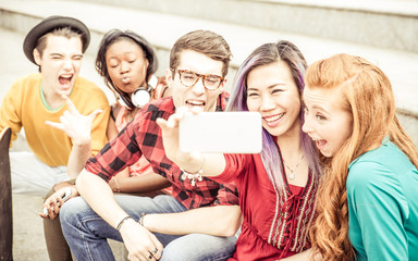 Group of teenagers sitting on the stairs and taking selfie