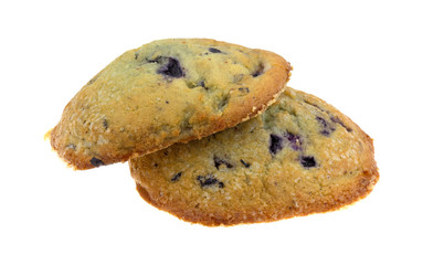 Side view of two freshly baked blueberry muffin tops isolated on a white background