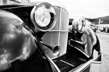 Old vintage car headlight close up. Black and white photo