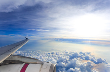 viewpoint Wing of windows airplane flying above the clouds in the sky