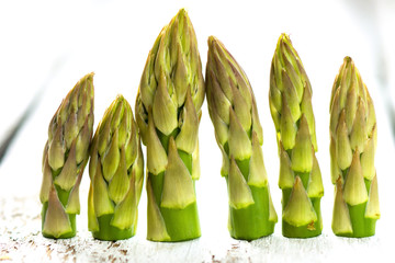 Delicious green asparagus on a wooden background 