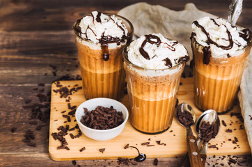 Homemade coffee cocktail with whipped cream and liquid chocolate