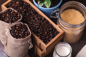 Jute bags with coffee beans, milk and sugar