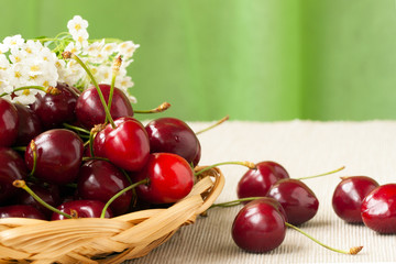 Rire fresh sweet cherries on a wicker plate