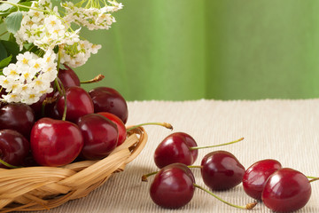 Rire fresh sweet cherries on a wicker plate