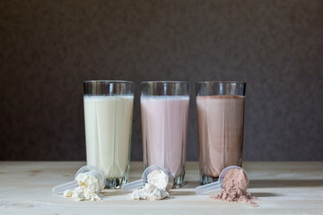 Three rest milk, chocolate, blueberry and banana drinks on table  