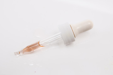 dropper vial of essential oil isolated on white background