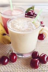 Cherry and banana and milk smoothie. Milkshake with cherries and bananas. 