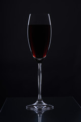 Glass with a long leg on a black background