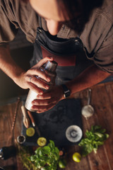 Bartender preparing a cocktail with shaker