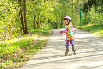 young girl in protective equipment and rollers in park, outdoor