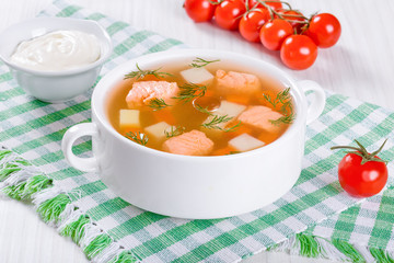 salmon soup with vegetables and dil, close-up