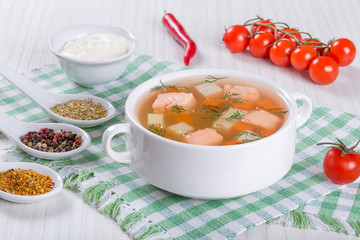 Salmon soup seasoned with dill  in white bowl