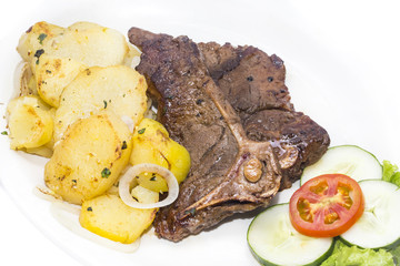 T Bone steak with potatoes and vegetables