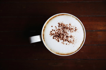 cappuccino coffee on wood background in coffee shop