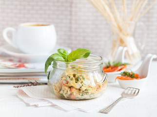 Unusual supply breakfast in a glass jar: scrambled eggs