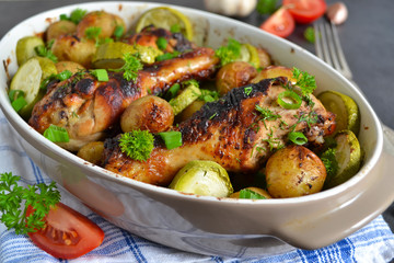 Baked potatoes with chicken and vegetables on a black background
