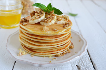 Pancake with banana, covered with honey or maple syrup with copy