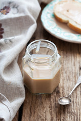 Homemade condensed milk with cocoa and coffee. Rustic style