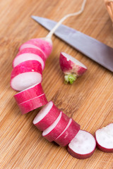 Sliced radishes on the wooden board