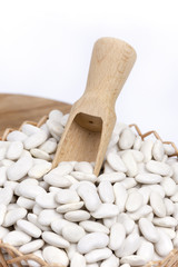 Fototapeta na wymiar Pile of white beans with wooden spatula spoon