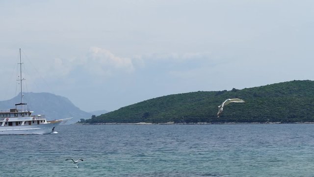 Tourist boat passing by the island in the background. Island Badija near Korcula. Spring 2016.