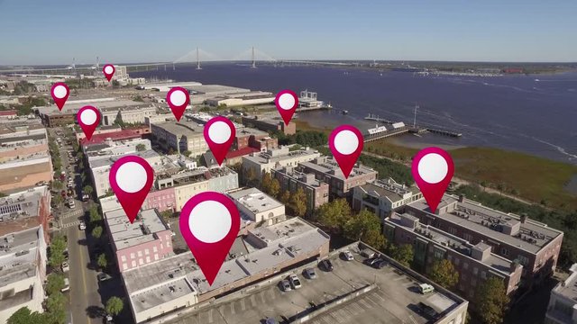 An aerial establishing shot of Charleston, South Carolina as GPS waypoint markers animate over random buildings.	