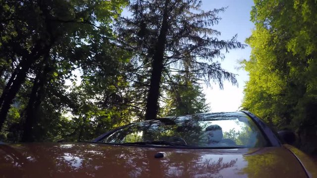 Driving convertible car at sunset