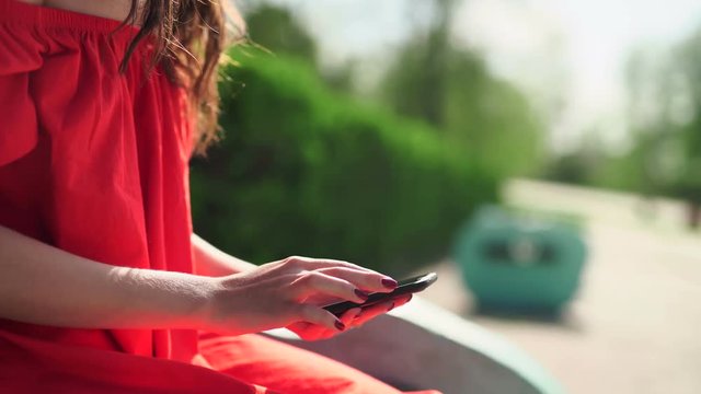 woman in red dress holding a phone with app mobile wallet