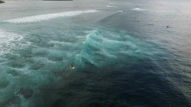 Aerial view of huge ocean waves and surfing in Bali indonesia