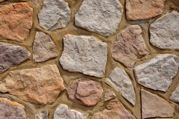 Colorful textured stone rock wall.  Graphic resource background or backdrop.