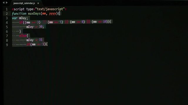 Copy/pasting sections of javaScript code and forming a long script on screen, shot under a slight angle and with noticeable DOF blur