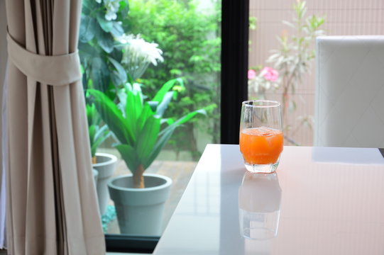 Orange juice put on white table outdoor background