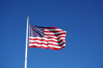 waving USA flag against blue sky