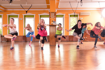 Group training girls exercising indoors.