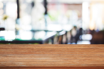 Top of wooden table with blurred cafe background