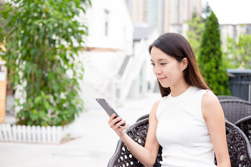 Fototapeta premium Woman sending sms on mobile phone