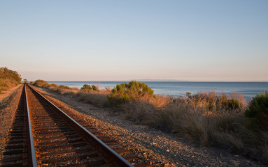 Fototapeta premium Railroad tracks on the Central Coast of California at sunset